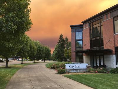 City Hall under smoke filled sky