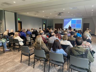 A crowd listens to a lecturer at a 2023 Speaker Series event