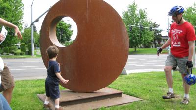 Youngster interacting with an art installation near the Wilsonville Library. 