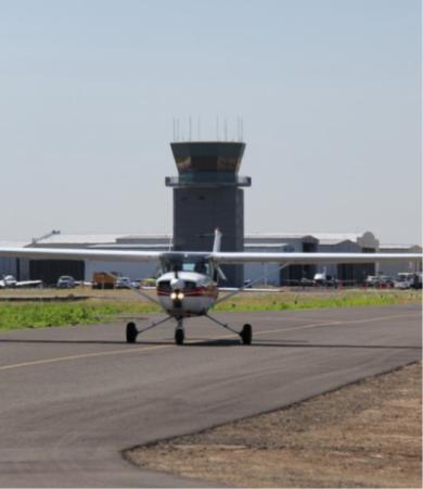 small plane on runway at Aurora Airport