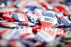 a collection of red, white and blue election badges